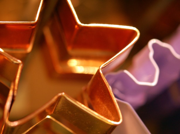 gold  star shaped cookie cutter and part of a  pink cookie cutter