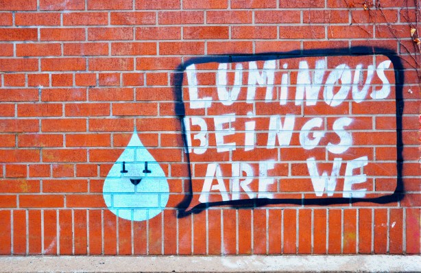 graffiti that says luminous beings are we