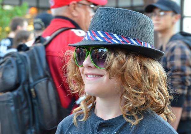 big sunglasses, a fedora, and a big smile!