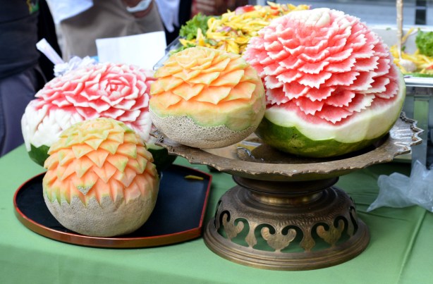 canteloupes and watermelon that have been carved to look like flowers with many petals