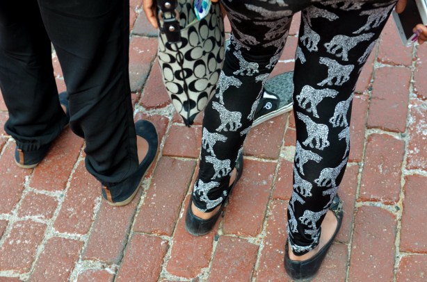 3 legs - one with black pants, two with black & silver pants. A black and white purse too.