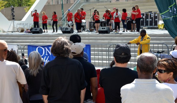 Samba Squad, a group of musicians, performs on stage.