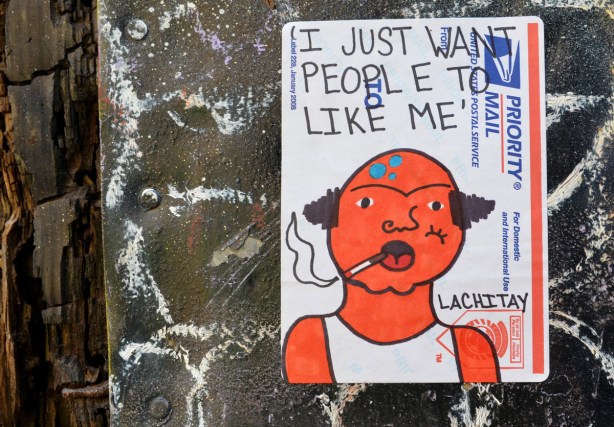 I just want people to like me.  A sticker in McDougall Lane, a good use of US Priority Mail labels.
