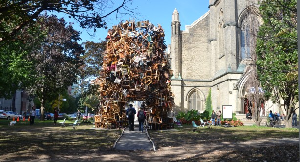 a large pile of chairs sits in front of a church