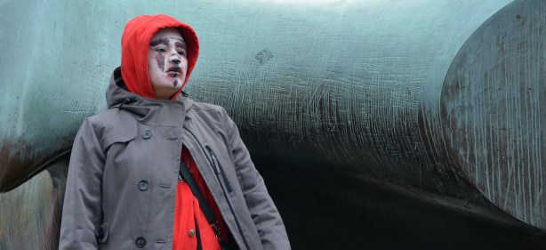 A woman with make up on her face to make her look like a zombie.