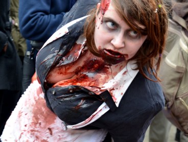 a woman with lots of fake blood on her chin and down her front