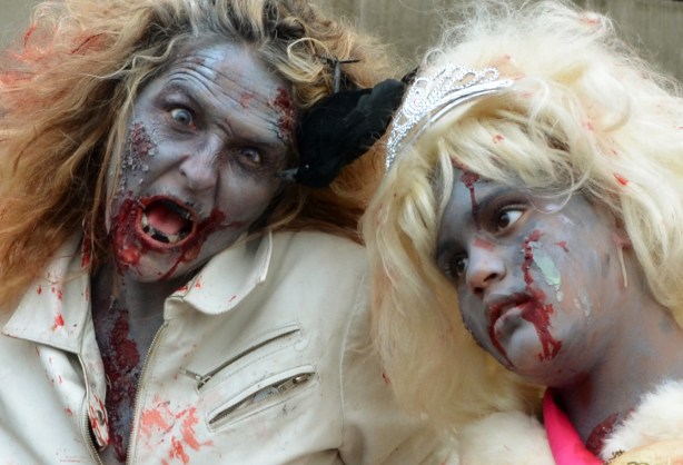 a mother and daughter dressed up as zombies.  Frizzy hair, grey skin and lots of fake blood dripping from their mouths.
