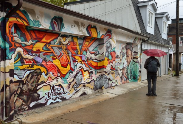 large piece of street art on a couple of garage doors. 