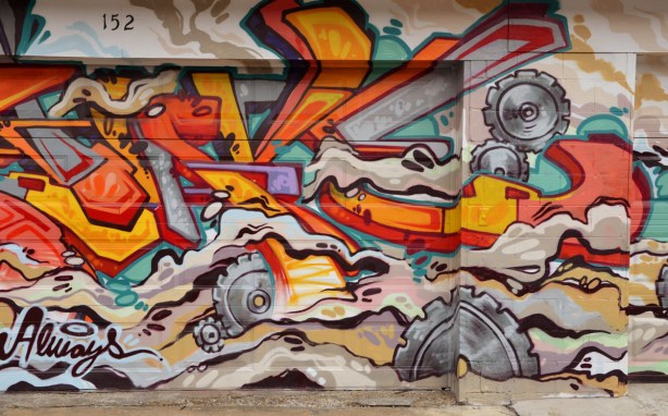 a large piece of street art on a garage door. 