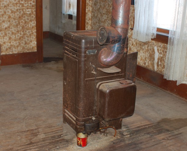 in the middle of living room there is an old oil burning stove.  It is near the middle of the room.  