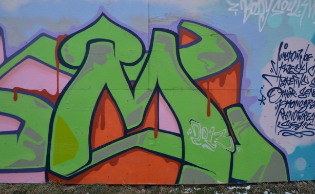 green and orange graffiti tage on blue background