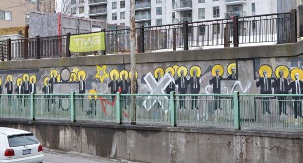 a line of men in suits as part of a mural 