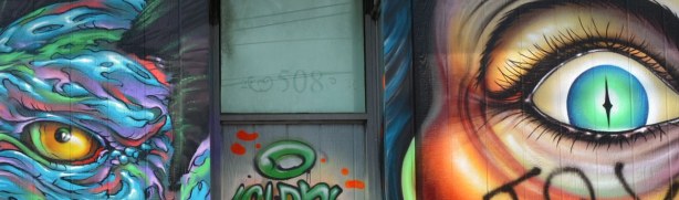 The number 508 is above the doorway.  An eye, part of two different murals, is on either side of the door. 