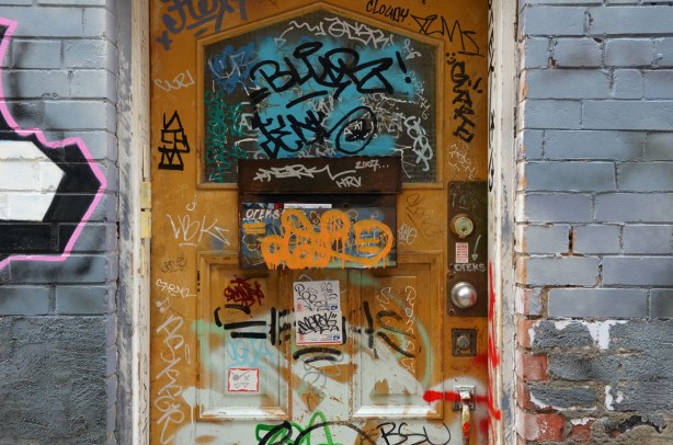 Doorway covered with stickers and scribbles