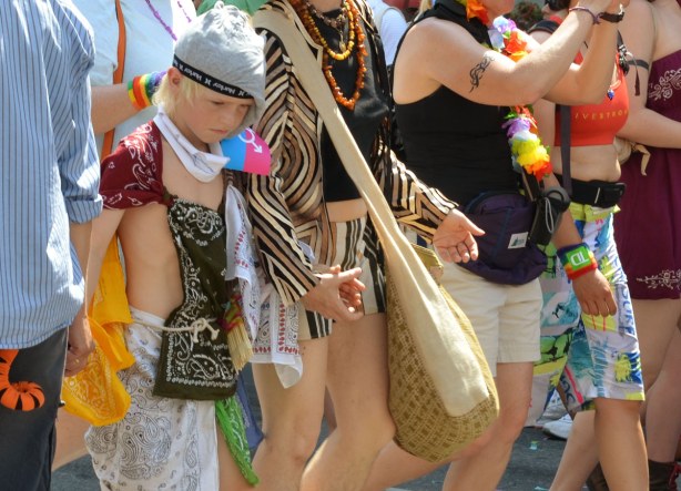 A line of walkers in the dyke march including one younger girl who has her head down