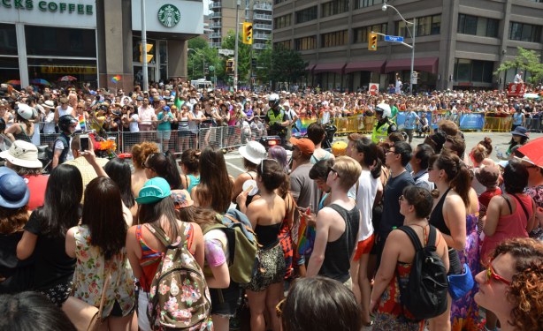 many people lining the route of the pride parade on Yonge St.