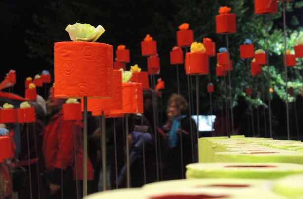 rolls of orange and red toilet tissue look like candles