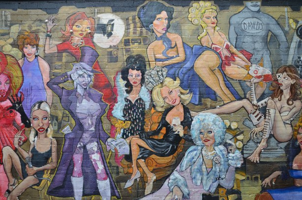 detail from mural - group of people in flamboyant clothes lounging around