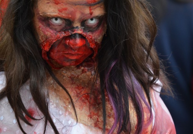 zombie from Toronto zombie walk - a woman with very bloody face, vacant stare, and long dark hair