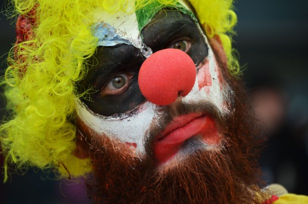 zombie from Toronto zombie walk - close up of zombie clown with yellow curly wig and a big red nose 