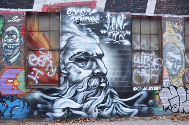 Street art in Graffiti Alley, Six Six Demigods black and white face of an old man with a flowing beard 