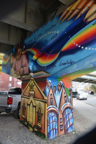 painting of the Enoch Turner school on one of the pillars supporting Adelaide St. East in Toronto.  Other Corktown houses are also painted here on the lower part of the pillar.  
