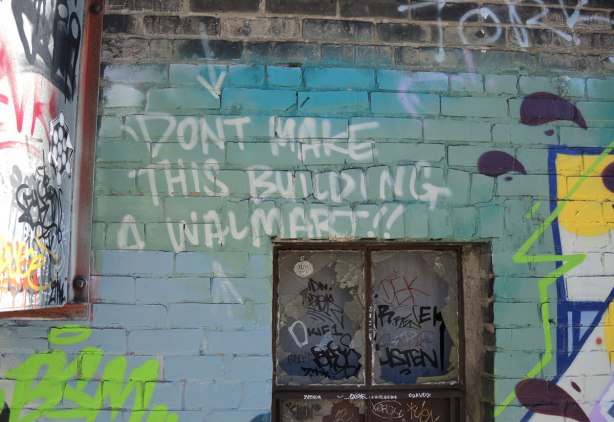 words written in white paint - "Don't make this building a Walmart"