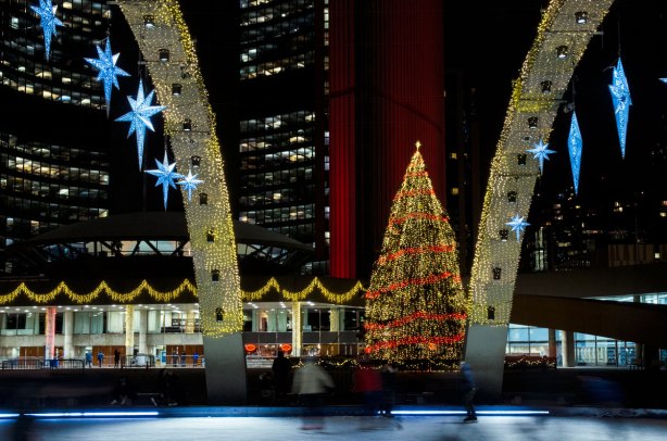 skating rink with brightly lit Chrsistmas tree behind it