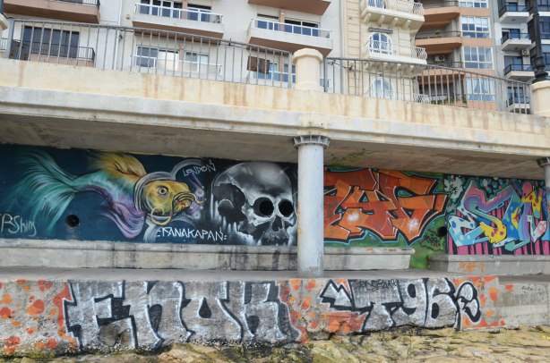 graffiti on a wall - skull and tags.