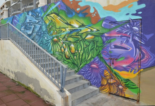 Colourful graffiti on a wall beside a set of stairs.