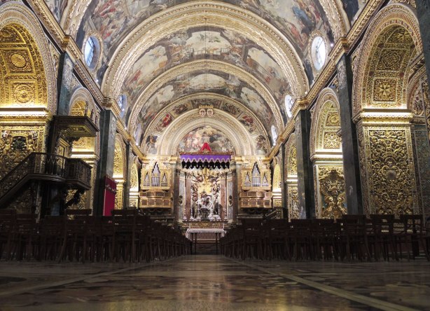Looking down the nave towards the main altar of a very decorated cathedral