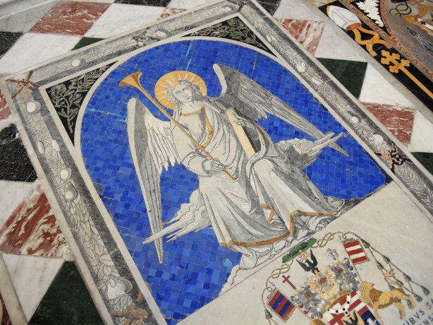 Tiles on the floor of the cathedral, close up of an angel on a blue background.