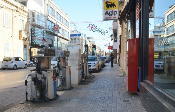 gas pumps on a sidewalk filling station, Agip, on a street in the town of Mosta