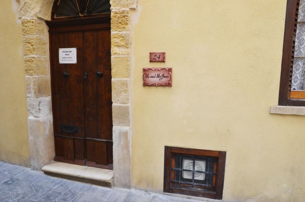 front of a house with a brown wood door and a sign that says Me and Mrs. Jones