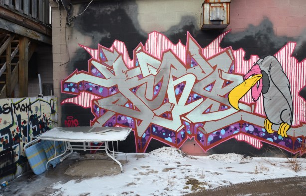 graffiti buzzard and tag behind a house. 