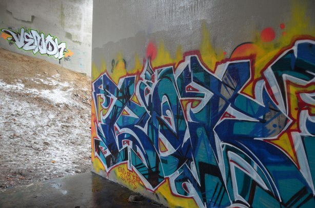 Graffiti tags under a bridge