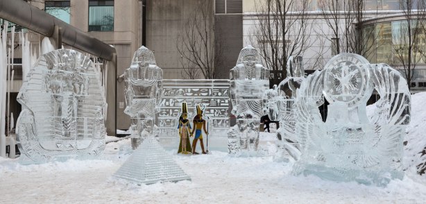 Four ice sculptures with Ancient Egyptian themes - King Tut, and a pyramid amongst them.   Also a wall of hieroglypics with two guards beside it. 