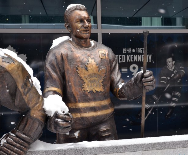 Bronze statue of Maple Leaf hockey player Ted Kennedy, standing behind what is supposed to be the boards between the players bench and the ice. 