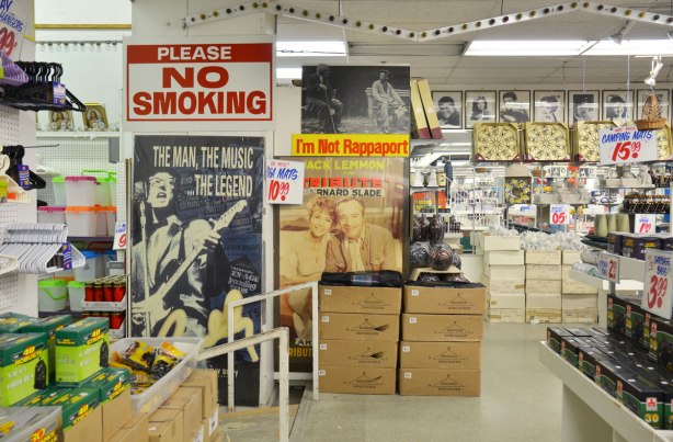 Interior photograph of Honest Eds store with its eclectic mix of merchandise.  Big No Smoking sign on the wall, some old movie posters on the wall too.  