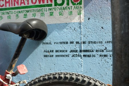 the signature part of a mural, Chinatown BIA, Chinese lettering and the names of the artists. 