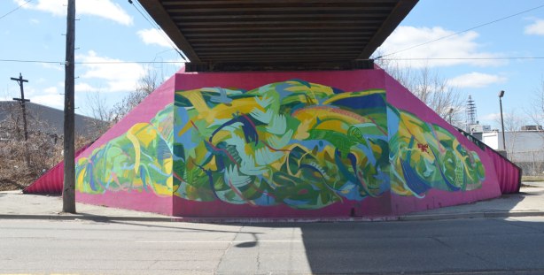 Mural of a skein of wool in bright colours on the underpass of a bridge