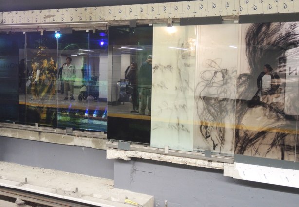 new art, pictures of people on the subway, on glass panels installed at Union Station platform  several panels with pictures of people but it is highly reflective so you can see the people waiting on the platform as well 