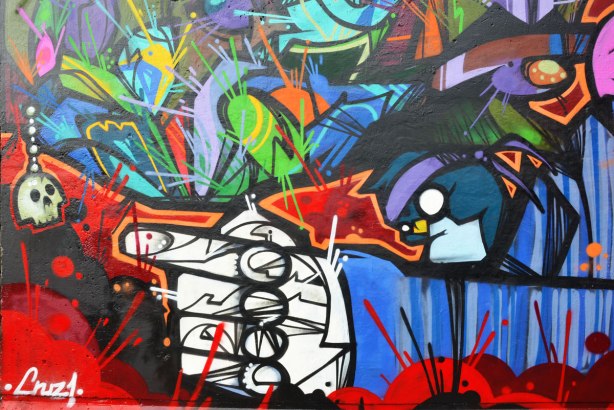 street art painting under a railway bridge - a white hand with finger pointing to the left 