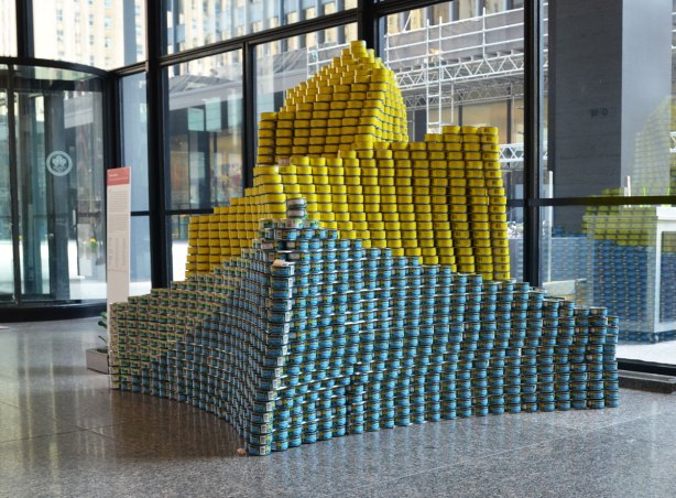sculptures on display that were entered in a contest in support of the Daily Food Bank, sculptures made of canned food in a theme pertaining to hunger awareness - a calla lily in yellow and blue cans