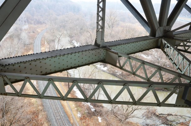 steel girders under the Millwood bridge with the train tracks and Don River below. Lots of bolts holding this bridge together!