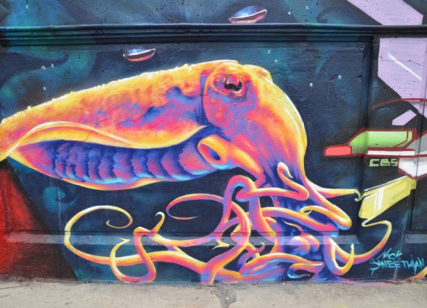 street art - brightly coloured, fluorescent like, giant squid, a steet art painting signed by Nick Sweetman