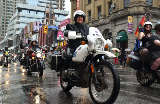 motorcycles in the rain, dyke march parade, down Yonge St. in Toronto