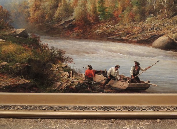 close up of part of a painting including part of the intricately carved frame.  THree men getting into a boat at the edge of a river 