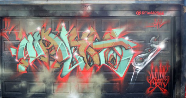 graffiti and street art in Graffiti Alley in Toronto - a tag in browns and turquoise