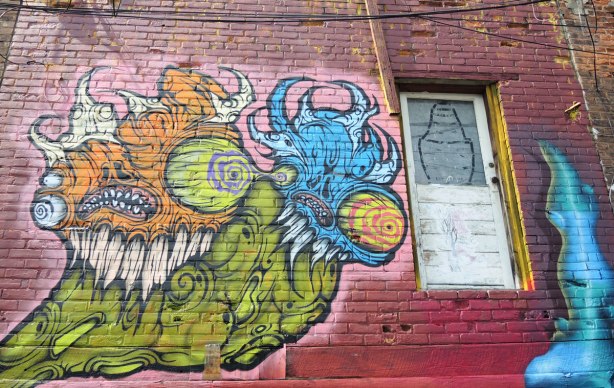 graffiti and street art in Graffiti Alley in Toronto - a very large grominator on the second storey, beside a door that goes nowhere 